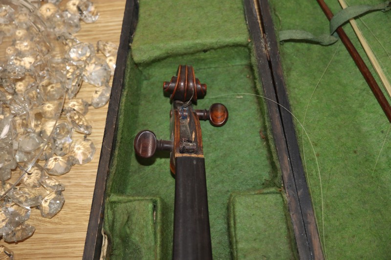 An early 20th century Saxon violin cased with bow and a cased banjo